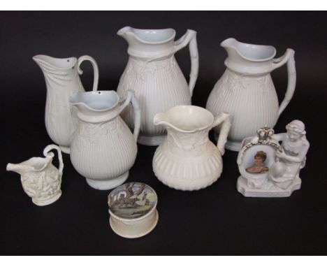 A graduated set of three Victorian matt glazed white ground jugs of ribbed form with moulded fruiting vine detail, three furt