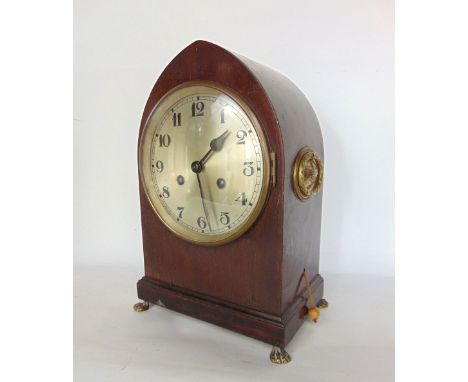 An Edwardian mahogany two train lancet bracket style clock, with 6" two train silvered dial upon cast brass paw feet, 33cm hi
