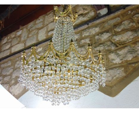 Gilt brass prismatic drop ceiling light, six bulb fitting with cast garland swags and finial's