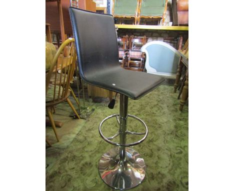 A vintage chrome and leather bar stool.
