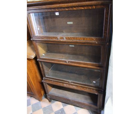 A four sectional Globe-Wernicke oak sectional bookcase with up and over doors