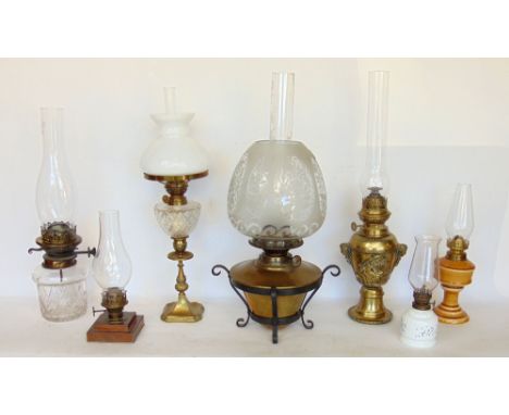 A collection of seven oil lamps to include a good cast metal baluster lamp in the French empire style cast with cherubs and m