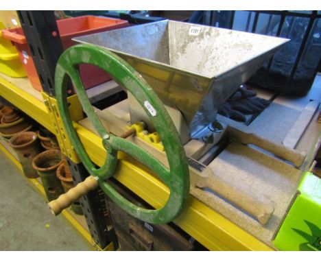 A fruit crusher with tapered hopper and hand operated cast iron fly wheel, label to beechwood frame Vigo Vineyard Supplies