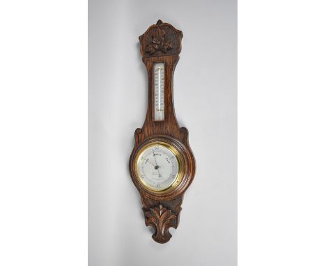 An Edwardian Oak Wheel Barometer with Carved Onion Top, Thermometer to Neck, 68cms High 