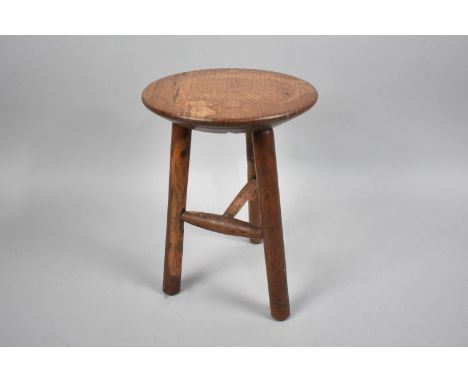 A Small Circular Topped Milking Stool with Tripod or 'Cricket'  Turned Supports, 20cms Diameter and 27cms High 