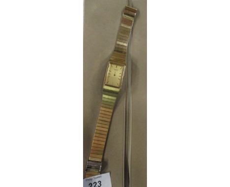 A Seiko gold plated stainless steel wrist watch, with rectangular dial and metal strap