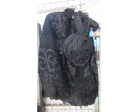A Victorian black cape, with lace overlay and applied scrolls, together with a Martyn Smiths Southsea black head piece with l