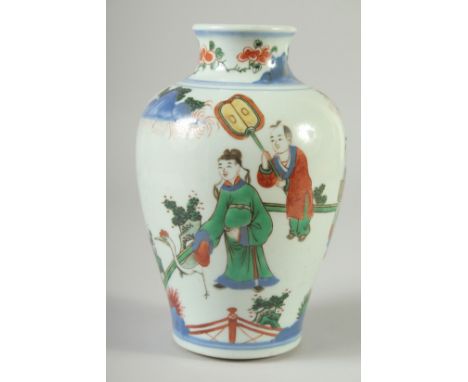 A CHINESE FAMILLE VERTE PORCELAIN VASE, painted with figures in a garden, 18cm high.