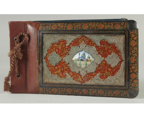 A FINE QAJAR SILVER MOUNTED LACQUERED WOOD BOUND ALBUM COVER, with small inset enamel plaque to centre depicting a mosque, th