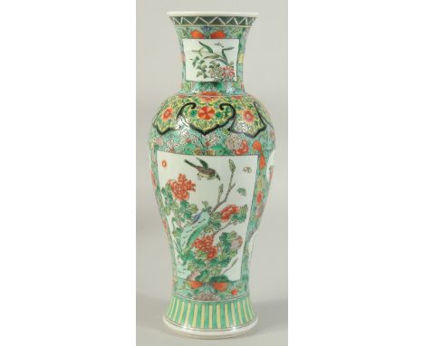 A CHINESE FAMILLE VERTE PORCELAIN VASE, painted with panels of flora, 30cm high.