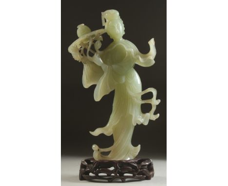 A CHINESE CARVED JADE FIGURE OF GUANYIN on a fitted wooden base, figure 24.5cm high.