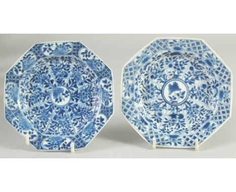 A SMALL PAIR OF CHINESE KANGXI BLUE AND WHITE PORCELAIN OCTAGONAL DISHES, painted with panels of foliate motifs, the base wit