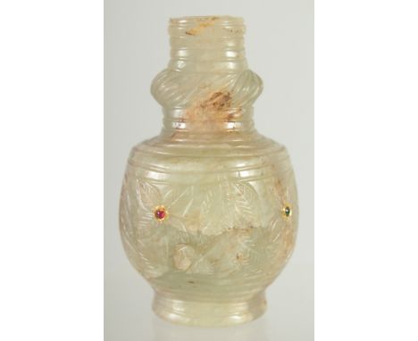 A FINE CARVED JADE BOTTLE, inset with small stones, 9cm high.