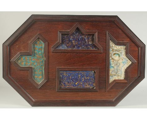 FOUR 12TH/13TH CENTURY PERSIAN LAJVARDINA AND KASHAN LUSTRE POTTERY TILES, united in a wooden frame, comprising three Lajvard