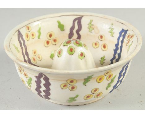 A TURKISH KUTAHYA POTTERY LEMON SQUEEZER, 14cm diameter.