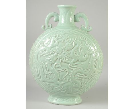 A FINE AND LARGE CELADON GLAZED CARVED DRAGON TWIN HANDLE MOON FLASK, the base with incised character mark, 44cm high.