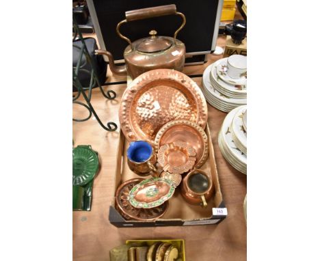 A copper kettle and an assortment of copper chargers, a trivet and a pin dish having enamel detailing, also included is a cop