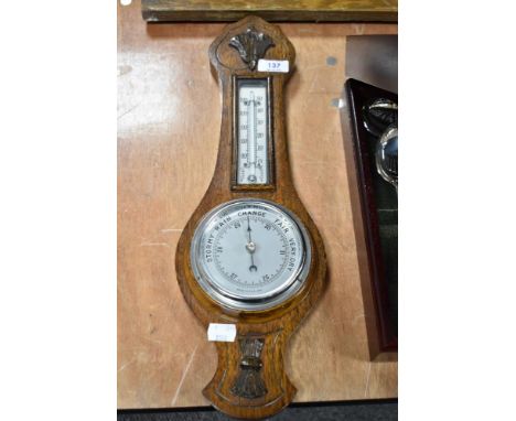 A mid century mahogany barometer, having wheat sheaf relief decoration to base.
