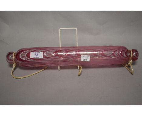 A Victorian glass Nailsea style rolling pin, decorated with bands of pink and white, 40cm long