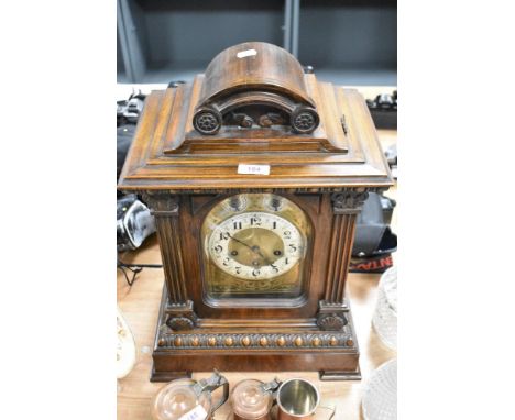 An early 20th century mahogany bracket clock, having beaded and carved detailing.