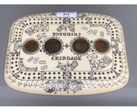 Antique style composition cribbage board decorated with impressions of dominoes, playing cards and inlaid with British pennie