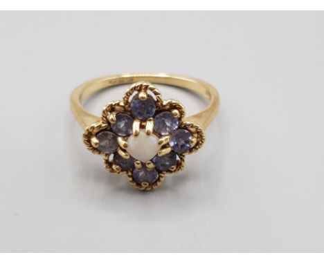 Ladies 9ct yellow gold purple stone +opal cluster ring, featuring a single opal set in the centre surrounded by8 purple stone