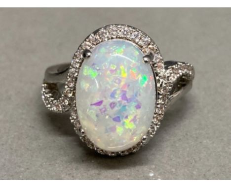 A silver CZ and opal style ring size M 3.9g gross