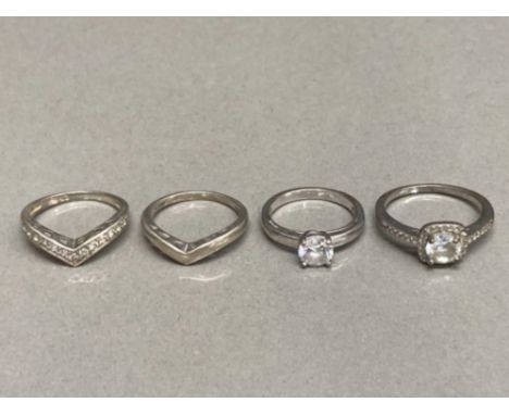 Three silver and CZ rings and a silver ring 8.7g gross