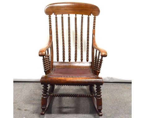 Beech framed rocking chair, broad cresting, bobbin turned spindles, close studded seat, turned and ringed legs on rockers, wi