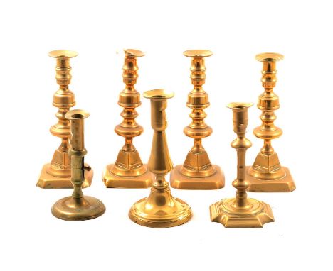 Georgian brass candlestick, 15cm; another 18th century brass candlestick; a near set of four brass candlesticks; and one othe