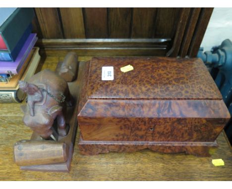 A birds eye maple caddy form box 28cm wide and a carved wood figure of an elephant moving logs (2) 
