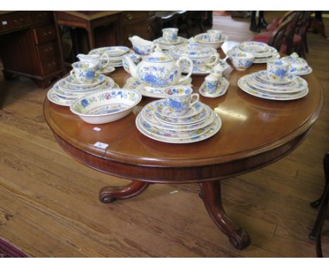 A Victorian mahogany snaptop breakfast table, the oval top on a baluster stem with tripod cabriole legs and scroll feet, 137c