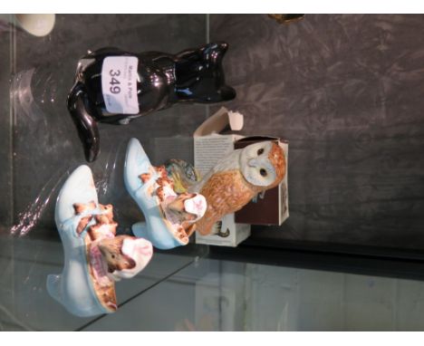 A Beswick figure of a barn owl, 12cm high, a Midwinter figure of a black cat, 10cm, and two Beswick figures 'Beatrix Potter's