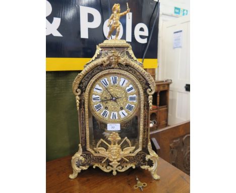 A 19th century French Boullework and ormolu mounted bracket clock, surmounted by a putti holding a staff, the arched scroll d