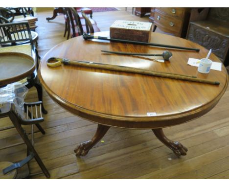 A mid Victorian mahogany snaptop breakfast table, the circular top on turned stem and tripod base of floral carved cabriole l