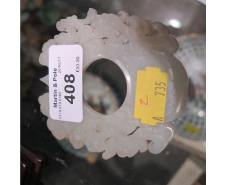 A jade scroll carved Bi disc, on a hardwood stand, 8cm high 