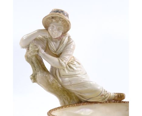 A Royal Worcester porcelain table centre bowl, in the form of a country girl with a basket, signed Hadley, circa 1900, height