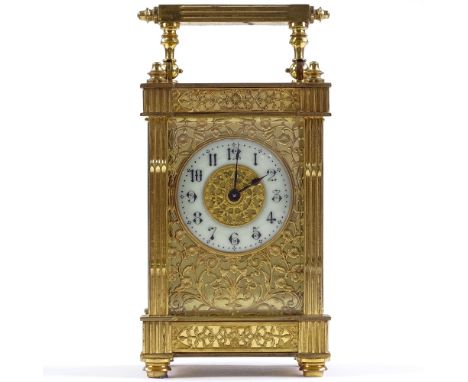 An ornate French gilt-brass cased 8-day carriage clock, with pierced fretwork gilt and enamel dial, and fluted corner columns
