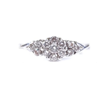 An unmarked white gold diamond cluster ring, with trio diamond shoulders, setting height 6mm, size K, 1.8g 