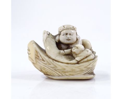 A Japanese Meiji period ivory netsuke, in the form of figures in a boat, length 4.5cm 