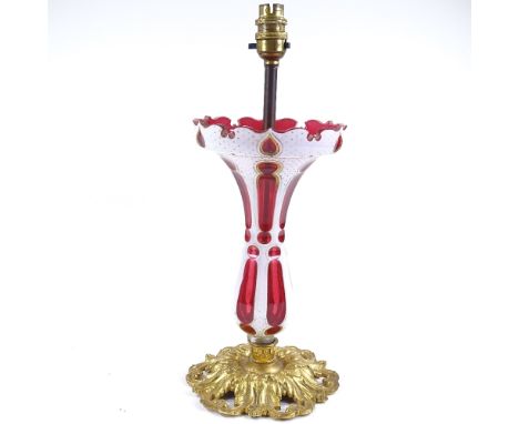 A Bohemian overlay glass table lamp on cast ormolu base, circa 1900, height to rim 29cm 