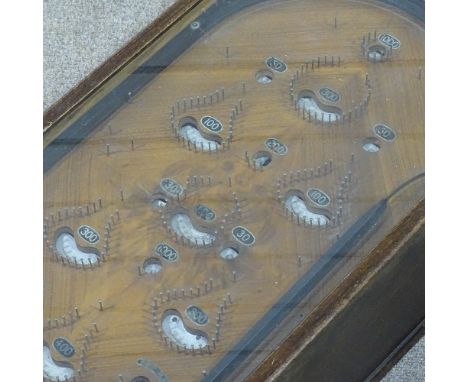 An oak-cased penny-in-the-slot bagatelle game, late 19th/early 20th century, length 2'11", width 16.5" 