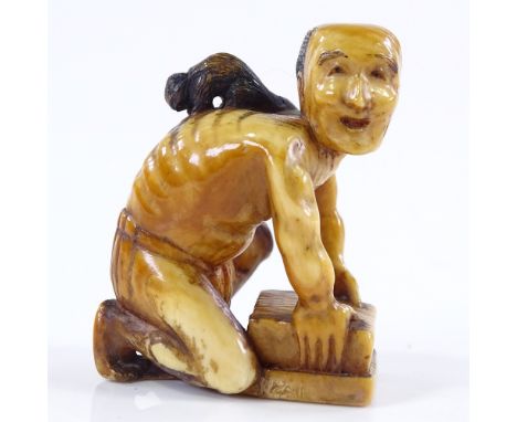 A Japanese carved ivory netsuke in the form of a rat catcher with a rat on his back, 18th or 19th century, signed under base,