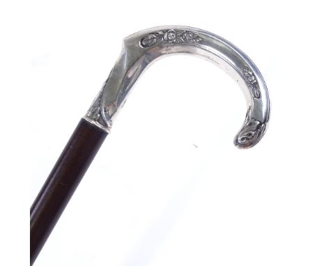 A Continental silver-handled walking stick, with floral embossed handle 