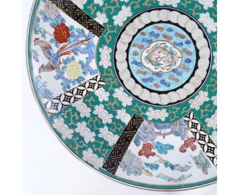A large Japanese porcelain charger with painted enamel decoration, diameter 45cm 