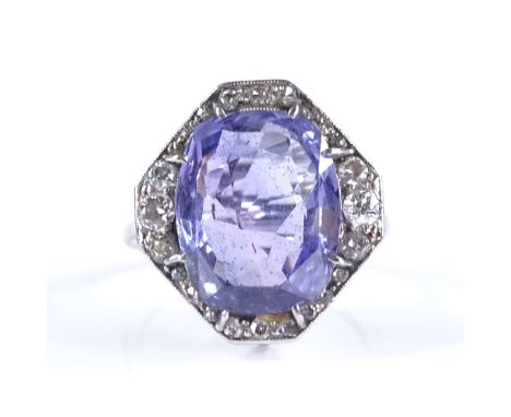 An Art Deco sapphire and diamond panel ring, unmarked white metal settings, with pierced scrollwork under bridge, panel heigh