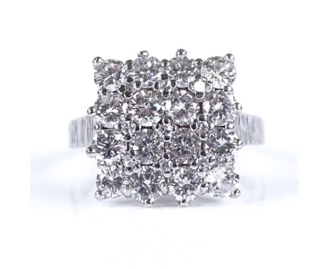 An unmarked platinum diamond cluster panel ring, with small diamond corner spacers, setting height 14.5mm, size M, 6.8g 