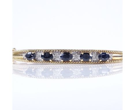 A 9ct gold sapphire and diamond hinged bangle, internal width 59mm, internal height 48mm, 14g 