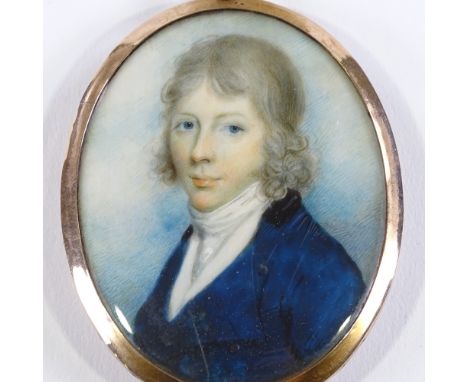 An early 19th century miniature watercolour on ivory, portrait of a young gentleman wearing a blue coat, unmarked gold frame 