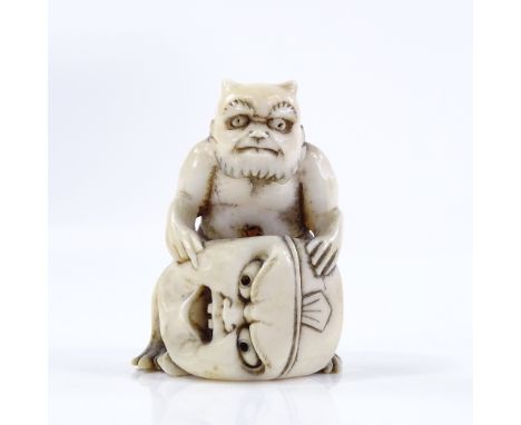 A Japanese Meiji period ivory netsuke, in the form of a demon and mask, height 4.5cm 